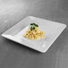 A white Elite Global Solutions square melamine plate with pasta and parsley on it.