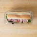 A ham sandwich in a 9" x 5" x 3" clear plastic hoagie container with a clear lid.