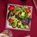 A salad on a WNA Comet clear plastic square salad plate.