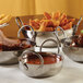 An American Metalcraft stainless steel balti dish filled with food.