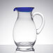 A clear glass pitcher with a blue rim and handle.