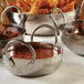 An American Metalcraft stainless steel balti dish filled with food.