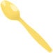 A Creative Converting yellow heavy weight plastic spoon on a white background.