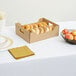 A Sabert small catering tray with bagels, donuts, and apples on a table.