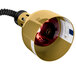 A polished brass Cres Cor hanging heat lamp with a black cord and a red light inside.