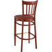 A Lancaster Table & Seating metal slat back bar stool with mahogany wood grain finish and burgundy vinyl seat.