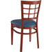 A Lancaster Table & Seating Spartan Series metal window back chair with mahogany wood grain finish and navy vinyl seat.