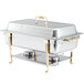 A silver Vollrath chafer with a gold side handle.