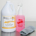 A white jug of Noble Chemical all-purpose cleaner with a Noble Chemical foaming spray trigger on the counter next to a cloth.