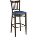 A Lancaster Table & Seating metal slat back bar stool with navy vinyl seat.