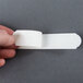 A hand holding a roll of white 3M Safety-Walk tape.