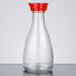 A close-up of a clear glass Town Red Top Soy Sauce bottle with a red cap.