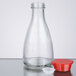 A close-up of a clear glass Town Red Top Soy Sauce bottle with a red lid.