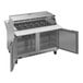 A stainless steel Beverage-Air refrigerated sandwich prep table with open doors.