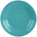A close-up of a Fiesta turquoise luncheon plate with a circular pattern on the rim.