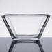 A clear Libbey square glass bowl on a table.
