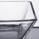 A close-up of a Libbey square glass bowl with a black rim.