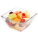 A Libbey square glass bowl filled with fruit on a white background.