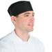 A man wearing a black Chef Revival baker's skull cap with mesh top.