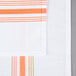 An orange cloth napkin with white stripes on the edges.
