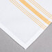 A white and gold striped Snap Drape Softweave cloth napkin.