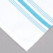 A white cloth napkin with blue and white stripes.