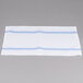 A white table with blue striped Snap Drape Softweave cloth napkins.
