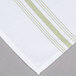 A white cloth napkin with a green striped border.