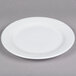 A Tuxton Sonoma bright white china plate with an embossed wavy rim.