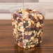 A D&W Fine Pack clear plastic deli container filled with nuts and seeds.
