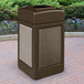 A brown rectangular Commercial Zone StoneTec waste receptacle with riverstone panels on a brick surface.