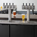 A Beverage-Air beer dispenser with four beer taps on a counter.