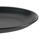 A black Hall China oval platter with a black rim.
