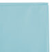 A pastel blue plastic table cover in a blue plastic bag with a zipper on a white background.