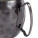 A close-up of a Libbey hammered antique copper metal mug with a handle.