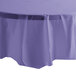 A purple Creative Converting disposable plastic table cover on a white table.