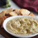 A bowl of roasted eggplant puree with pita chips.