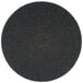 A 3M black circular floor pad with a black center