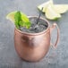 A World Tableware copper Moscow Mule mug with ice and mint.
