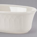 A white oval shaped bowl with a curved design.