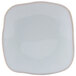 A white square Tuxton Artisan china plate with a small square design on the edge.