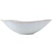 A close-up of a white Tuxton China Capistrano bowl with a small rim.