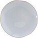 A white Tuxton Artisan china plate with a black rim.