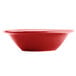 A red Tuxton China fruit bowl with a white background.