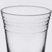 An Arcoroc clear glass with a rim on a white background.