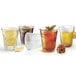 A group of Arcoroc party glasses filled with different drinks.