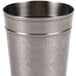 A silver cup with a pattern on it.