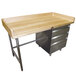An Advance Tabco wood workbench with metal drawers.