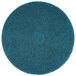 A blue 3M circular floor pad with a circle in the middle.