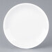 An Arcoroc white porcelain brunch plate with a small rim.